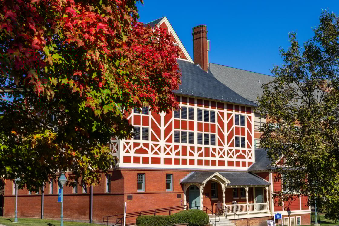 A photo of Peikoff Alumni House with fall foliage. 