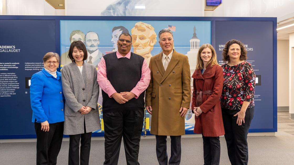 A photo of six people in a line smiling for the camera. From left to right, Gallaudet President Roberta Cordano; Ai Minakawa of the Deaf and Hard of Hearing Child Resilience Center; Damien Marsh of DHHCRC; Congressman Mark Takano; Dr. Lori Day of DHHCRC; Board of Trustees Liaison Kim Bianco-Majeri.