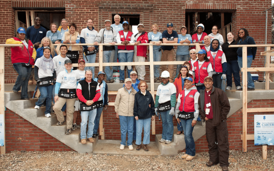 President Carter and his wife Rosalynn stand in front of the house they built with volunteers in Ivy City, D.C. in 2010.